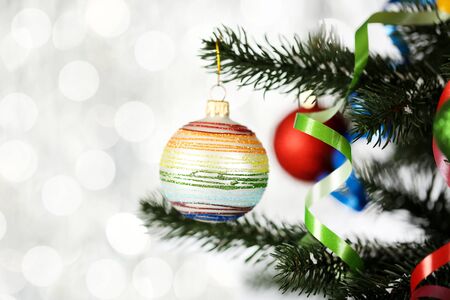 Christmas fir tree with ornaments on blurred lights backgroundの写真素材