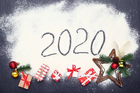 Number 2020 on flour with gift boxes and ornaments