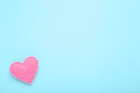 Pink fabric heart on blue backgroundの写真素材