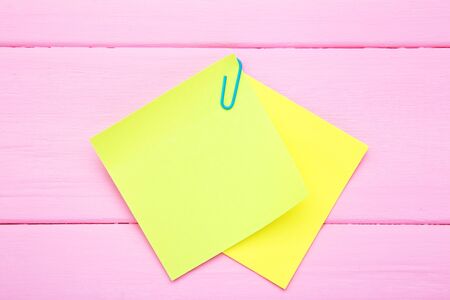 Paper sticky notes on pink wooden table