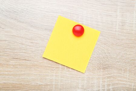 Paper sticky note on wooden table