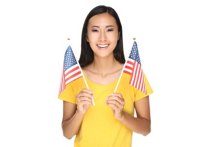 Young woman holding American flag isolated on white backgroundの写真素材