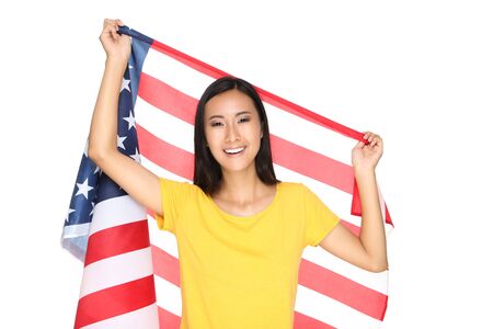Young woman holding American flag isolated on white backgroundの写真素材