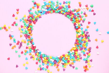 Heart shaped sprinkles on pink backgroundの写真素材