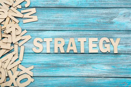 Word Strategy by wooden letters on blue tableの写真素材
