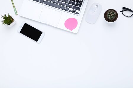 Laptop computer with office supplies on white backgroundの写真素材