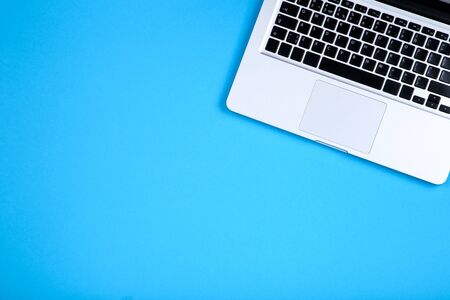 Laptop computer on blue backgroundの写真素材