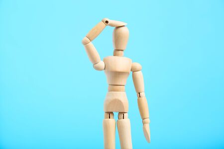 Wooden figure having headache on blue backgroundの写真素材