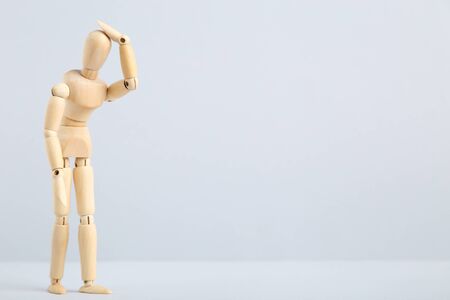 Wooden figure having headache on grey backgroundの写真素材