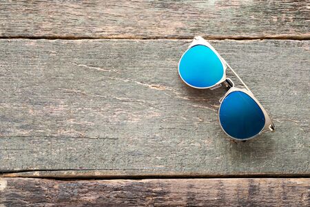 Fashion sunglasses on grey wooden tableの写真素材