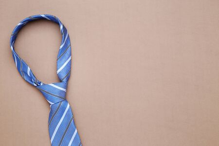 Striped necktie on brown backgroundの写真素材