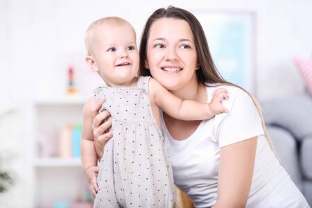 Young mother with baby boy at home