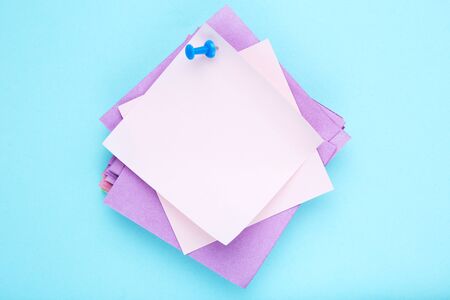 Paper sticky notes on blue backgroundの写真素材