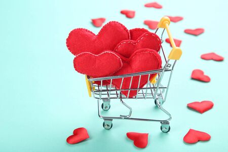 Fabric hearts with shopping cart on blue backgroundの写真素材