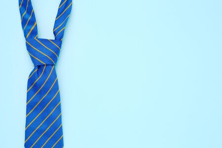 Striped necktie on blue backgroundの写真素材