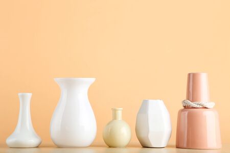 Different ceramic vases on beige backgroundの写真素材