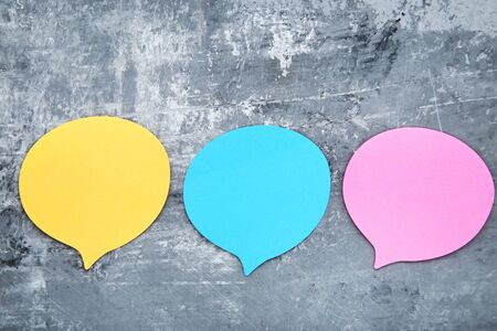 Paper speech bubbles on grey background