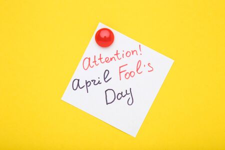 Text Attention April Fool's Day on yellow backgroundの写真素材
