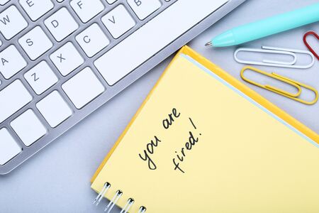 Text You Are Fired on paper with computer keypad