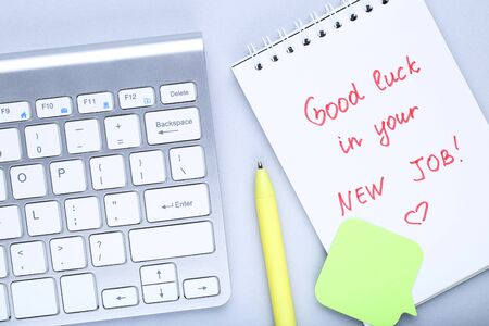 Text Good Luck In Your New Job on paper with computer keypadの写真素材