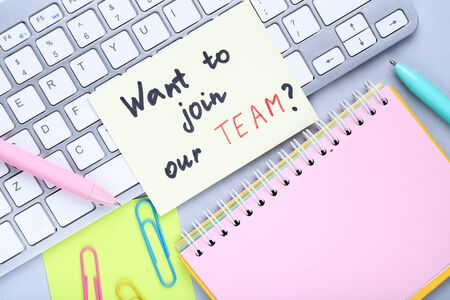 Text Want To Join Our Team with computer keypad, notepad and pensの写真素材