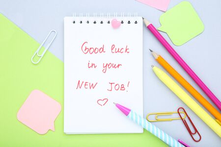 Text Good Luck In Your New Job on paper with pens and pencils