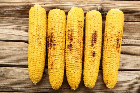 Grilled corn on brown wooden table