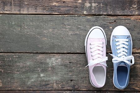 Different colorful sneakers on grey wooden tableの写真素材