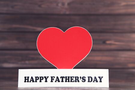 Text Happy Father's Day with red heart on brown wooden tableの写真素材