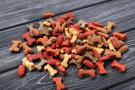 Dry pet food on black wooden tableの写真素材