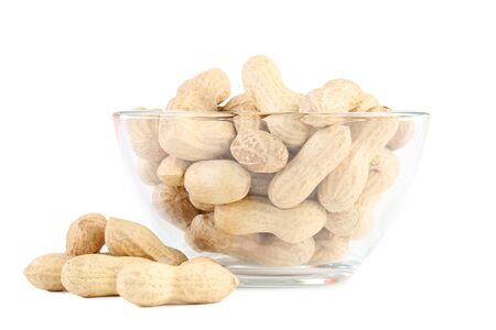 Peanuts in glass bowl isolated on white background