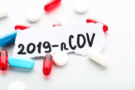 Text 2019-nCov with colorful pills on grey backgroundの写真素材