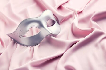 Carnival mask on pink fabric backgroundの写真素材