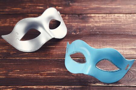Carnival masks on brown wooden tableの写真素材