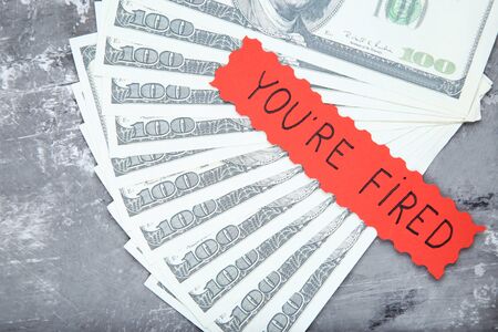 Text You Are Fired on paper with dollar banknotesの写真素材