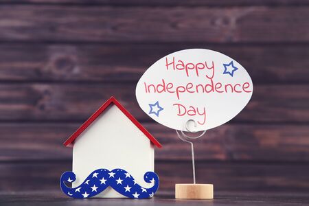 Text Happy Independence Day with house model on wooden backgroundの写真素材
