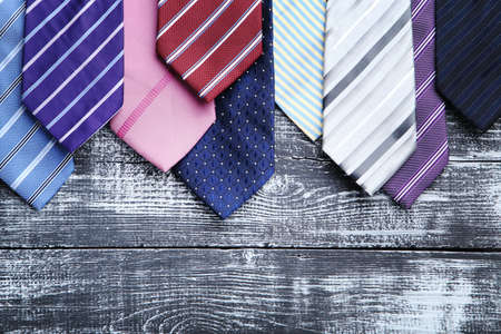 Colorful neckties on wooden table