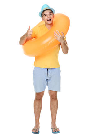 Young man with inflatable ring showing thumb up on white backgroundの写真素材
