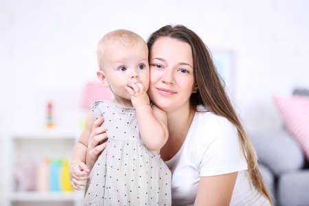 Young mother with baby boy at home