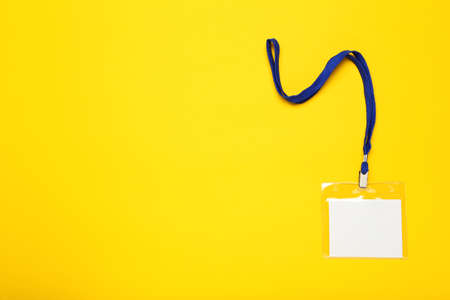 Blank white bagde on yellow backgroundの写真素材