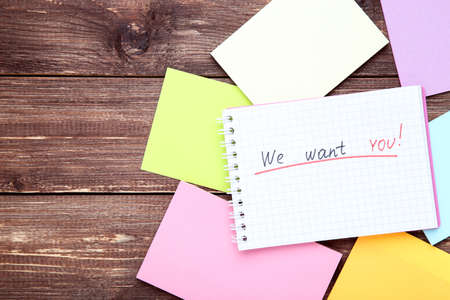 Text We Want You in notepad with colorful papers