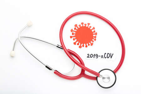 Text 2019-nCov with stethoscope and paper coronavirus on white backgroundの写真素材
