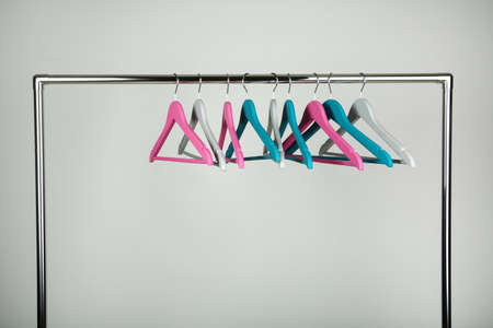 Colorful clothes hangers on gray backgroundの写真素材