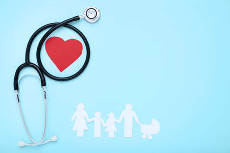 Family figures with red heart and stethoscope on blue backgroundの写真素材