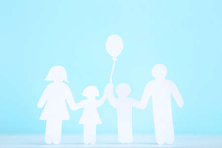 Paper family figures on blue backgroundの写真素材