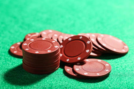 Poker chips on green table