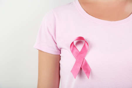 Woman with pink ribbon on t-shirt. Cancer concept.の写真素材