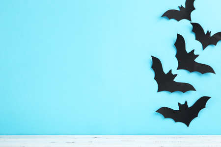 Halloween paper bats on blue background