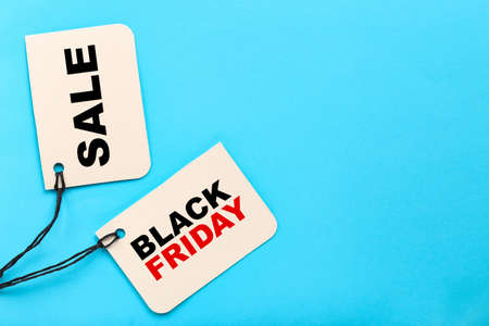 Sale tags with text Sale and Black Friday on blue background