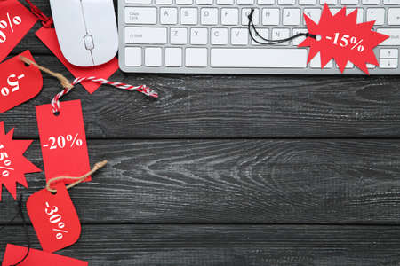 Keyboard, mouse and red tags on black backgroundの写真素材